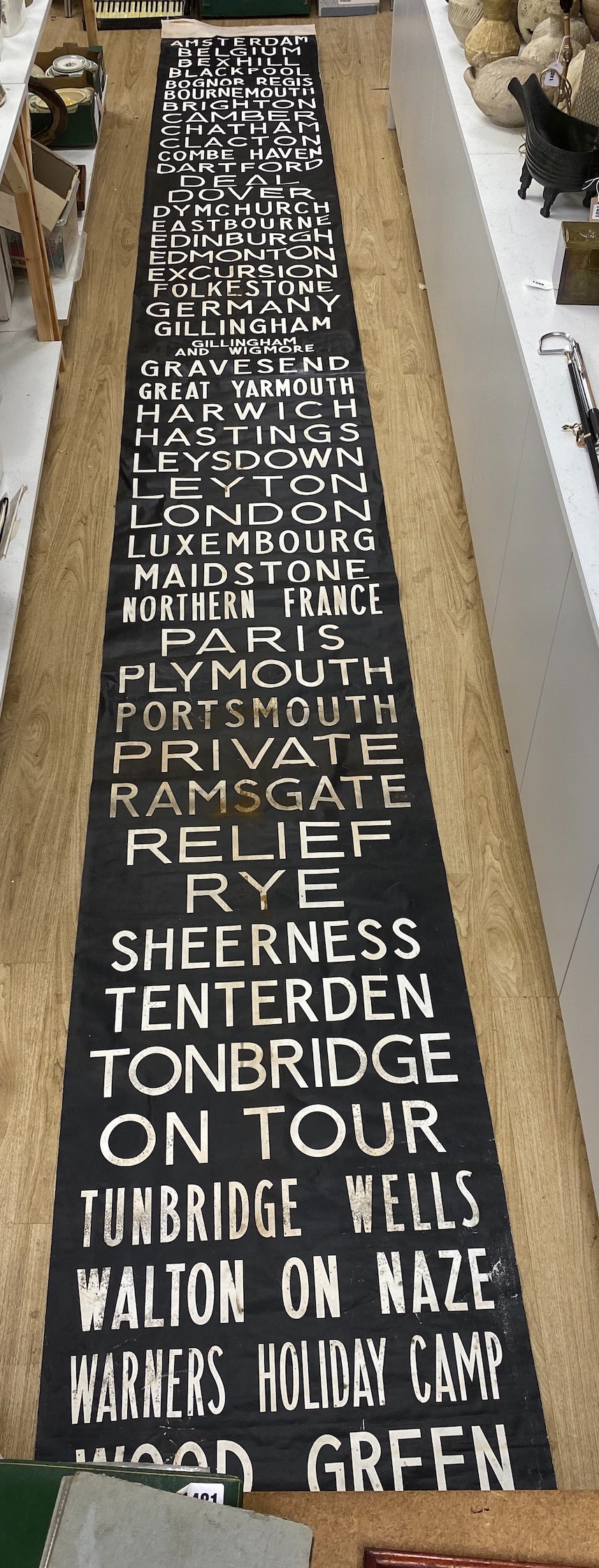 A painted canvas alphabetical list of European destinations including Sussex areas such as Brighton approximately 695x80cm